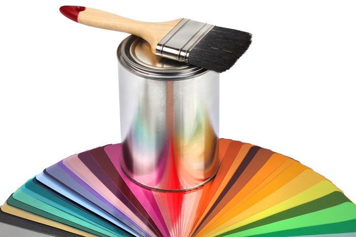 A paint brush, paint tin, and paint swatches